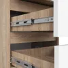 Close-up view of the interior of a wooden cabinet with drawers and metal drawer slides. Produktbild-Vorschau