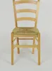 A wooden chair with a straw seat against a white background. Produktbild-Vorschau