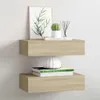Two wooden shelves mounted on a white wall, decorated with books, a plant, and a vase. Náhled obrázku produktu