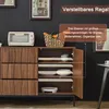 A sideboard with its cabinet doors open, displaying shelves and items. The background is dark, with framed pictures on the wall. Anteprima dell’immagine prodotto
