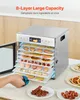 A person is shown removing a tray from a stainless steel food dehydrator filled with various dried fruits and meats. Podgląd zdjęcia produktu