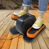 A person using a mini elliptical trainer at home. Voir les images du produit