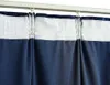 A close-up view of dark blue velvet blackout curtains hanging from a white curtain track. Náhled obrázku produktu
