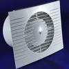 A white exhaust fan with a circular grille and blades, set against a dark blue background. Podgląd zdjęcia produktu