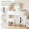 A white vanity table with a mirror, stool, and drawers, decorated with makeup and accessories. Voir les images du produit