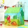 A children's play tent with dinosaur illustrations, set up indoors. Náhled obrázku produktu