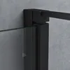 A close-up view of a black shower door frame and glass panel against a textured gray wall. Produktbild-Vorschau