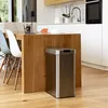 A modern kitchen with a wooden island and stainless steel trash can. Produktbild-Vorschau