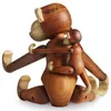 A wooden monkey toy with a baby monkey clinging to its back, set against a white background. Náhled obrázku produktu