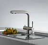 A modern kitchen sink with a stainless steel faucet and a bowl of kumquats. Anteprima dell’immagine prodotto