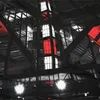 Interior view of a stadium or large building with prominent red and white lighting. Produktbild-Vorschau