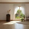 A sunlit room with a large window overlooking a garden. Náhled obrázku produktu