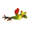 A ceramic figurine of a green frog lying on its back with a red heart above it. Produktbild-Vorschau