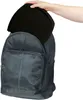 A hand is placing a black object into a black backpack. Produktbild-Vorschau