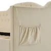 A close-up view of the side of a beige upholstered bed frame, showing a built-in storage pocket. Anteprima dell’immagine prodotto