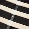 A close-up view of wooden slats and plastic fasteners on a bed frame. Náhled obrázku produktu