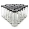 A group of empty glass jars with black lids arranged in a pyramid formation on a white background. Produktbild-Vorschau