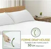 A white mattress with two pillows on it. A small inset shows a hand tucking a fitted sheet around a mattress. Produktbild-Vorschau