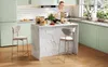 A woman is making coffee in a modern kitchen with a marble-patterned island and bar stools. Voir les images du produit