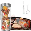 A stainless steel rolling grill basket filled with meat and vegetables, shown on a grill with other food items. Produktbild-Vorschau