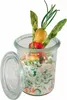 A glass jar filled with a creamy salad and topped with vegetables and herbs. Náhled obrázku produktu