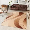 A living room scene with a sofa, armchair, rug, and side table. Produktbild-Vorschau