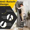 A woman is using a step ladder to adjust curtains in a room. Anteprima dell’immagine prodotto