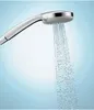A close-up shot of a shower head with water spraying from it against a gradient blue background. Produktbild-Vorschau