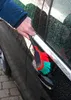 A person is cleaning a car door handle with a brush. Produktbild-Vorschau