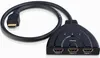 A black HDMI splitter with three input ports and one output cable. Produktbild-Vorschau