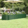 A green metal raised garden bed filled with purple hydrangeas, set in a grassy backyard with a table and umbrella in the background. Náhľad obrázku produktu