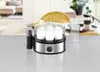 An egg cooker sits on a metallic surface with a blurry background of a dining area. Produktbild-Vorschau