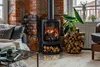 A cozy living room scene with a modern fireplace and a glass hearth plate. Produktbild-Vorschau