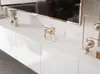 A modern white TV lowboard with decorative items on top. Voir les images du produit