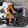 A woman is sitting in the trunk of a car with a folded electric bicycle next to her. The image highlights the bike's foldable features. Produktbild-Vorschau