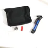 A black bag and a blue tripod are laid out on a white surface. Anteprima dell’immagine prodotto