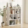 A white geometric bookshelf with 7 compartments filled with various decorative items and books, placed against a white wall with natural light casting shadows. Produktbild-Vorschau