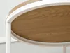 A close-up view of the edge of a round wooden table with a white frame. Náhľad obrázku produktu
