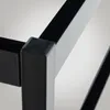 A close-up view of the corner of a black metal bed frame, showing a protective cap on the corner joint. Produktbild-Vorschau