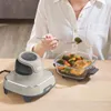 A person is using a Ninja CRISPi air fryer to cook a meal of salmon and vegetables. Anteprima dell’immagine prodotto