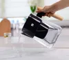 A hand is pouring water from a water filter pitcher into a glass on a kitchen counter. Náhľad obrázku produktu