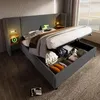 A modern bedroom with a bed that has storage underneath, featuring bedside tables with lights and USB ports. Anteprima dell’immagine prodotto