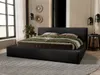 A bedroom scene with a black upholstered bed as the main focus. Náhľad obrázku produktu