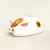 A white and orange cat-shaped computer mouse is shown against a light beige background. Náhled obrázku produktu