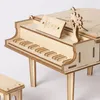 A close-up, eye-level shot of a wooden toy grand piano and its bench, set against a white background. Podgląd zdjęcia produktu