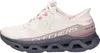 A side view of a beige Skechers slip-on shoe with pink and gray accents. Produktbild-Vorschau