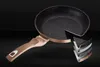 A frying pan with a cutaway showing its layered construction, presented against a dark background. Náhľad obrázku produktu