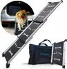 A dog is using a ramp to get into a car. The ramp is extended and appears to be made of metal and black rubber with bone-shaped grips. A folded ramp and a carrying bag are also shown. Produktbild-Vorschau