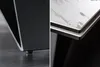A split image showing close-ups of two different table designs. The left side shows the base of a black table with a small, round foot. The right side shows the edge of a table with a white marble-like pattern and black and white layers. Produktbild-Vorschau