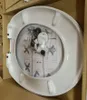 A new toilet seat in its packaging, placed inside a cardboard box. Podgląd zdjęcia produktu
